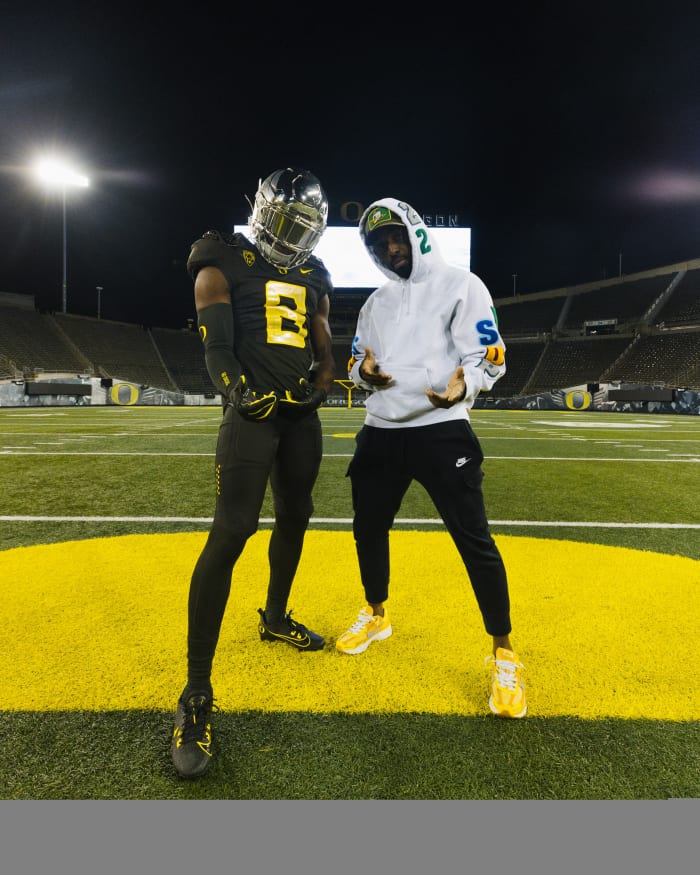 2025 Cleveland (Ohio) Shaker Heights defensive back Trey McNutt poses with Rashad Wadood inside Autzen Stadium.